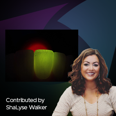 tooth lighted by green light in dark background and woman in white blouse