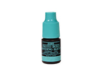 Small bottle of photo bond bonding agent with a turquoise cap on a white background