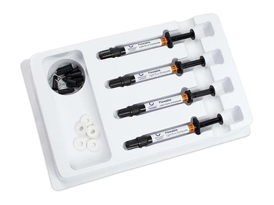 Set of dental materials including syringes and a tool on a white tray